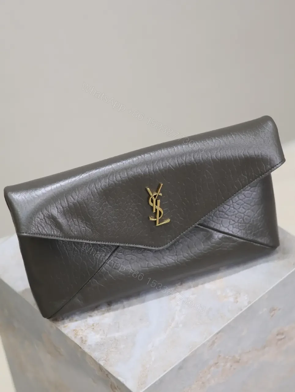 View 2 of Textured Black Leather Envelope Clutch with Gold Logo Signature