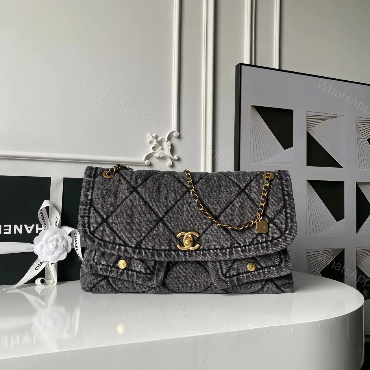 Chanel Maxi Flapbag in washed denim with gold-tone metal hardware — view 1