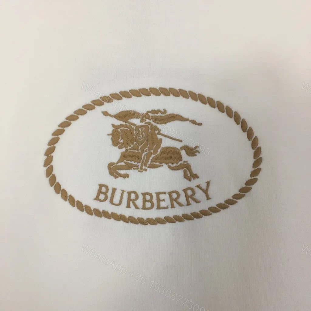 View 5 of Neutral Off-White Luxury Hoodie with Crest Embroidery