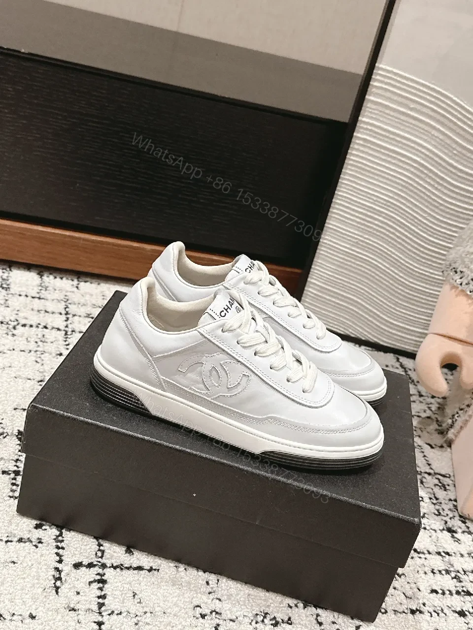 View 2 of Minimalist White Leather Sneakers with Subtle Chanel Detailing