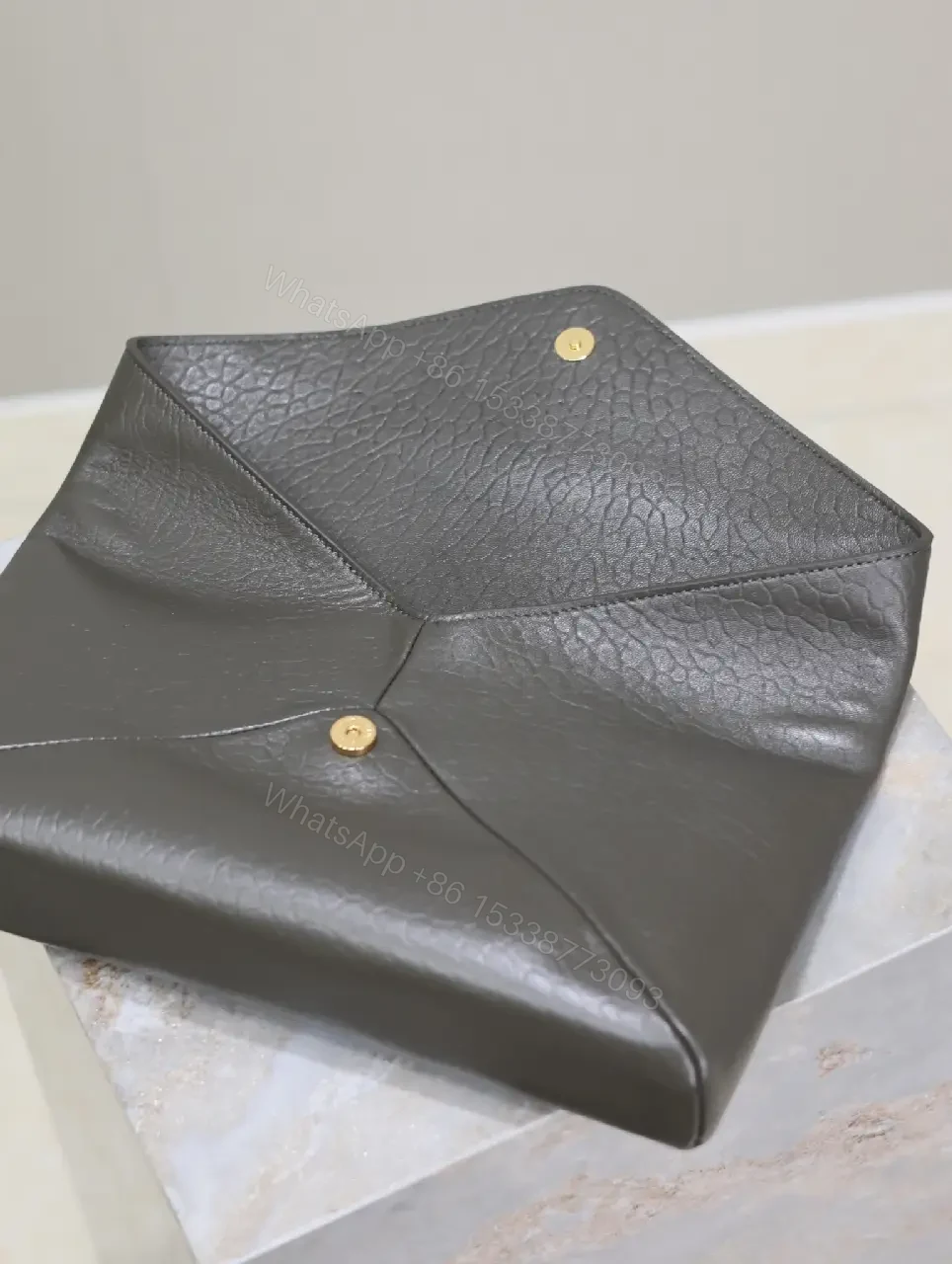 View 3 of Textured Black Leather Envelope Clutch with Gold Logo Signature