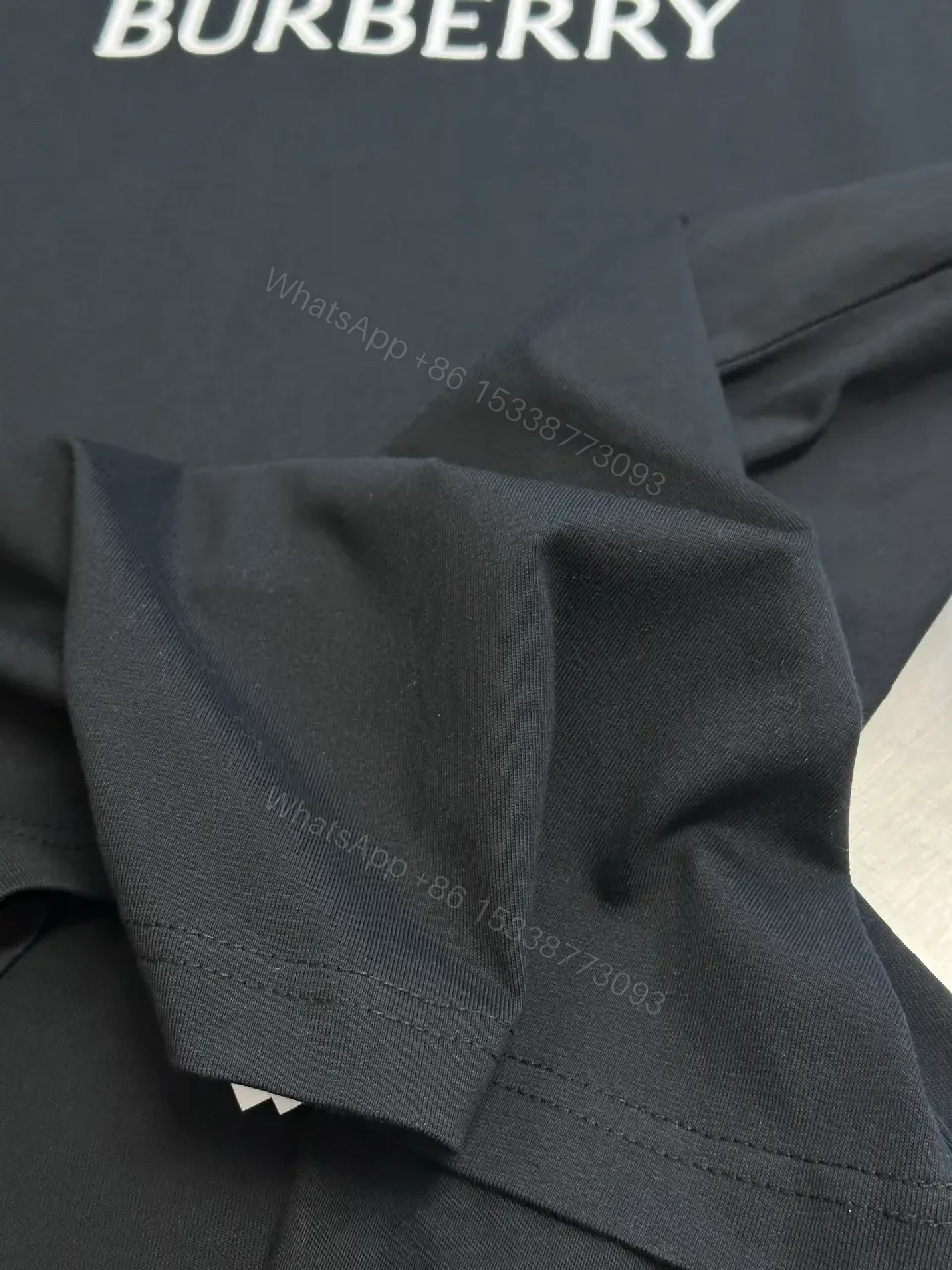 View 2 of Minimalist Black Cotton Tee | Relaxed Fit, Logo Accent, Everyday Luxury