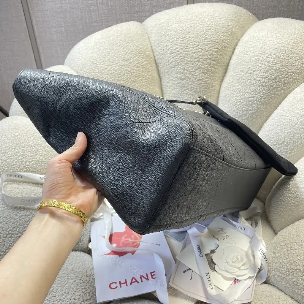 View 2 of Black Quilted Leather Shoulder Bag with Chain Straps and Chanel Logo