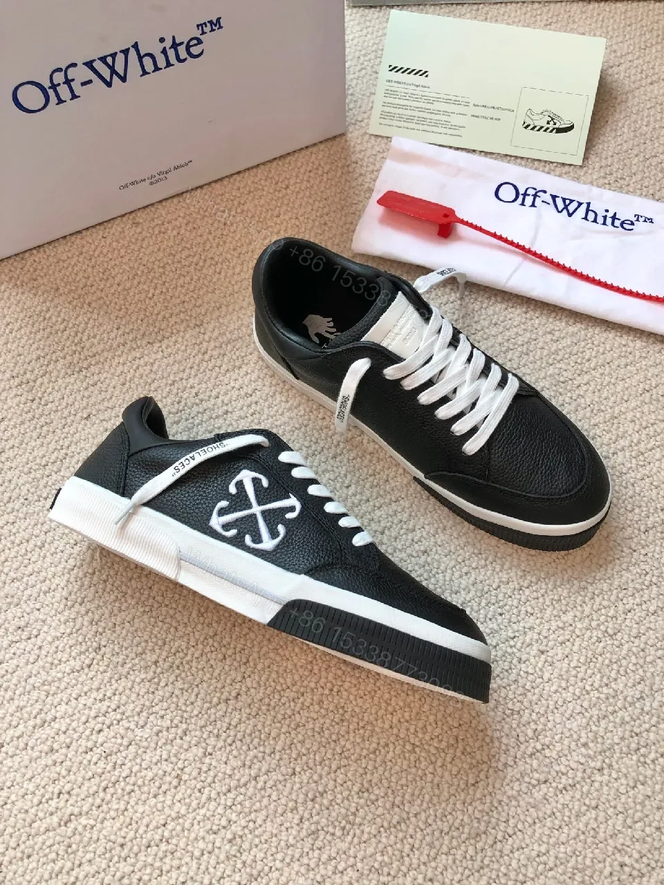 View 3 of Low-Top Black Pebbled Leather Sneakers with Signature Detailing