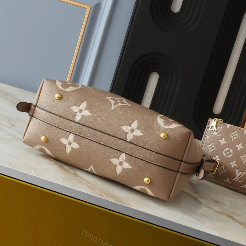 View 5 of Louis Vuitton Carryall PM Bicolor Monogram Empreinte Dove And Cream 29Cm M47180