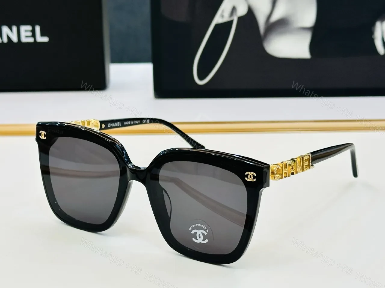 Bold Black Frame Sunglasses with Gold Detailing — view 1