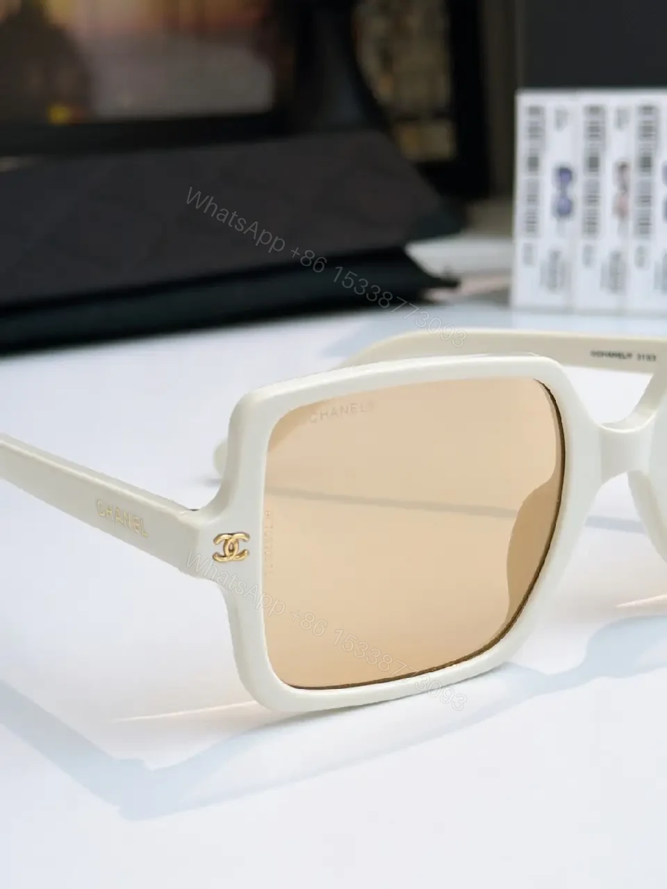 View 4 of Black Frame Oversized Sunglasses with Gold Chanel Logos, Matte Gray Lenses