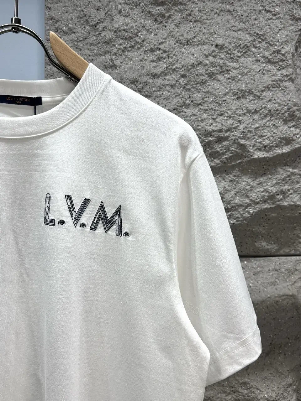 View 2 of Minimalist White Tee with Subtle L.V.M. Logo—Premium Everyday Essential