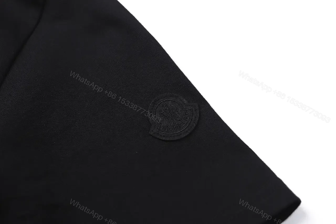 View 8 of Black Cotton Tee with Crest – Subtle Luxe Streetwear Top