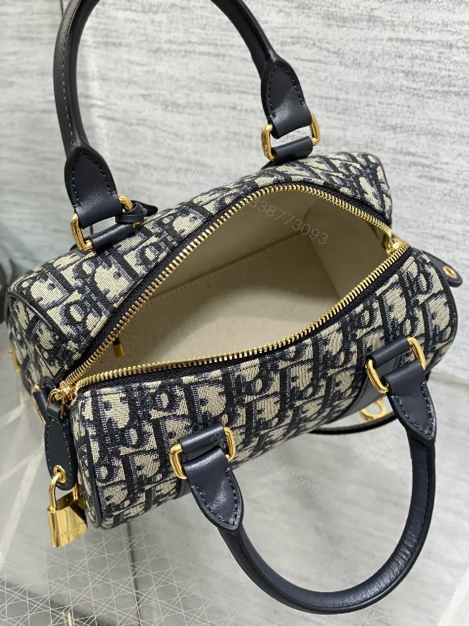 View 3 of Structured Luxe Navy Leather Mini Duffle Bag with Monogram Charm
