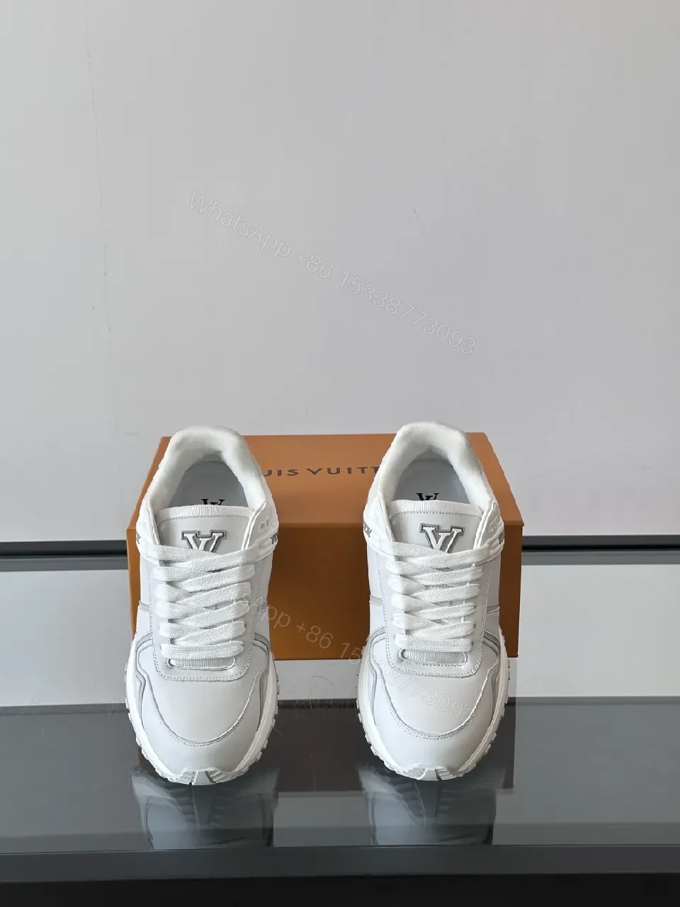 View 3 of Minimalistic White Leather Sneakers with Subtle Texture and Monogram Accent