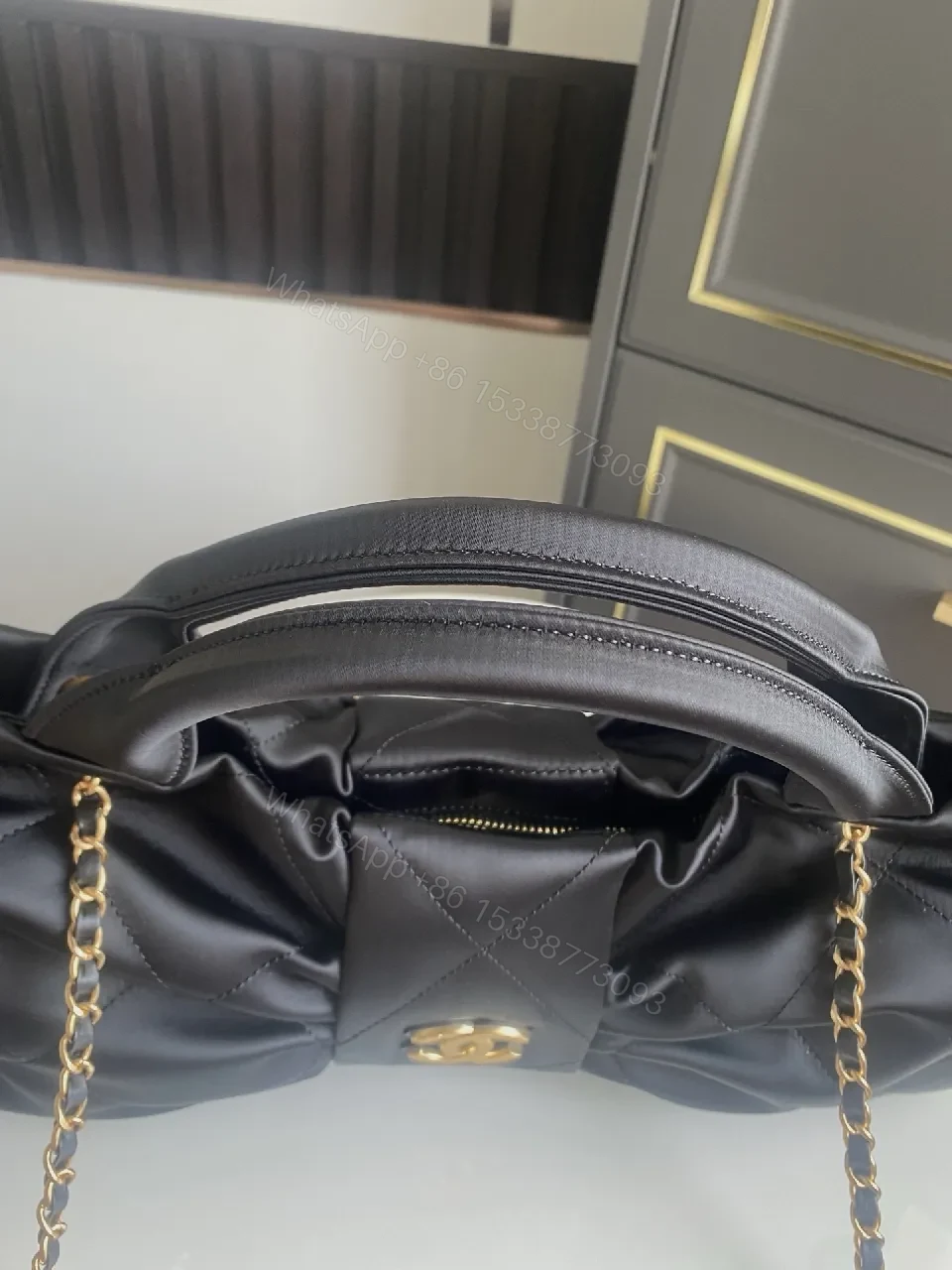 View 8 of Quilted Black Bag with Gold Emblem - Luxury Everyday Style
