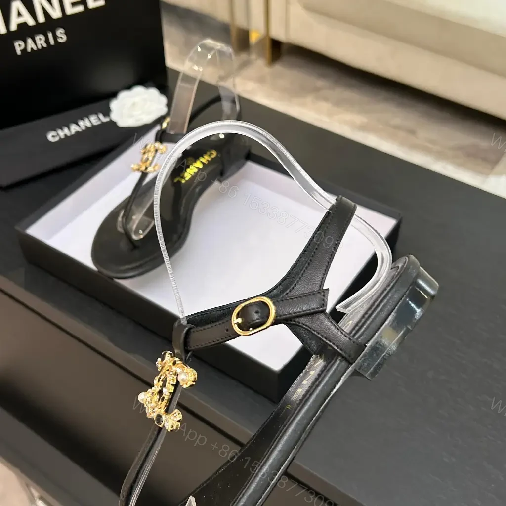 View 8 of Minimalist Black Leather Sandals with Gold Charms - Elegant Comfort
