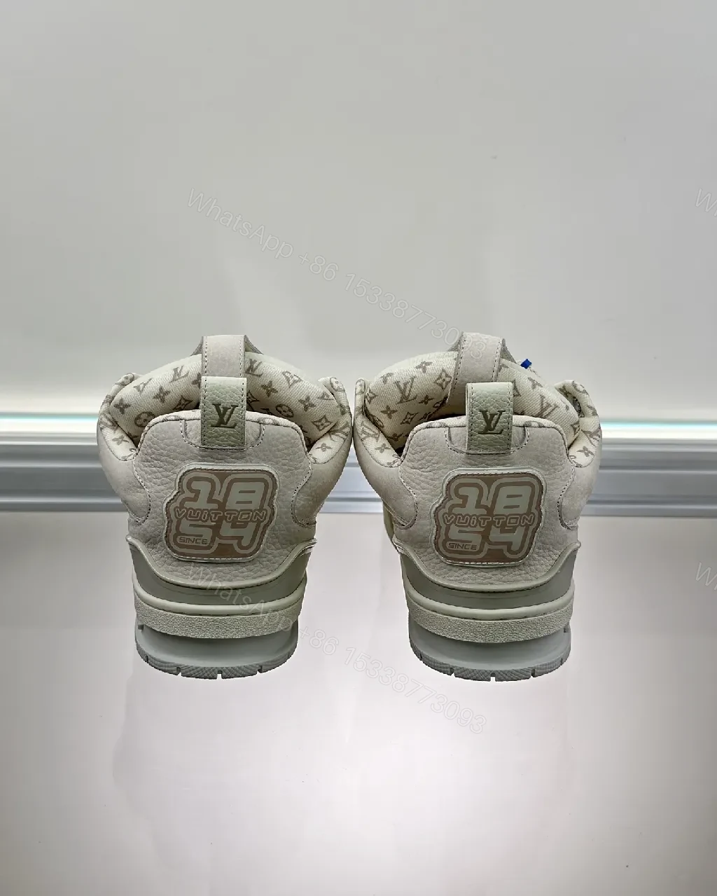 View 2 of Textured White Leather Sneakers with Signature Motif, Modern Luxury