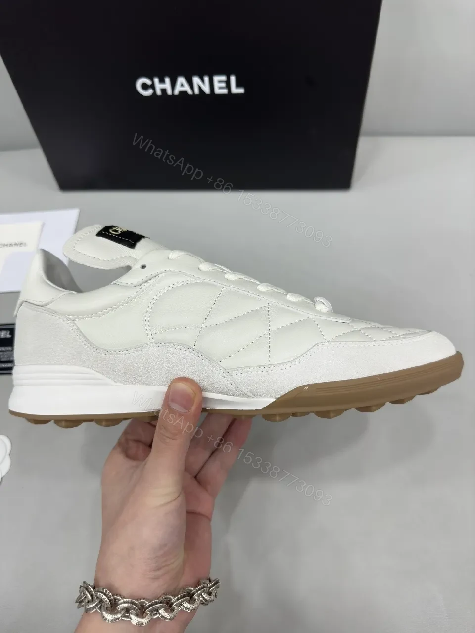 View 2 of White Quilted High-Top Leather Sneakers with Signature Details