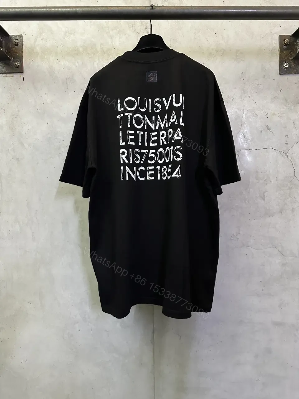 View 8 of Minimalist Black Tee with Subtle LV.M Emblem, Lux Cotton