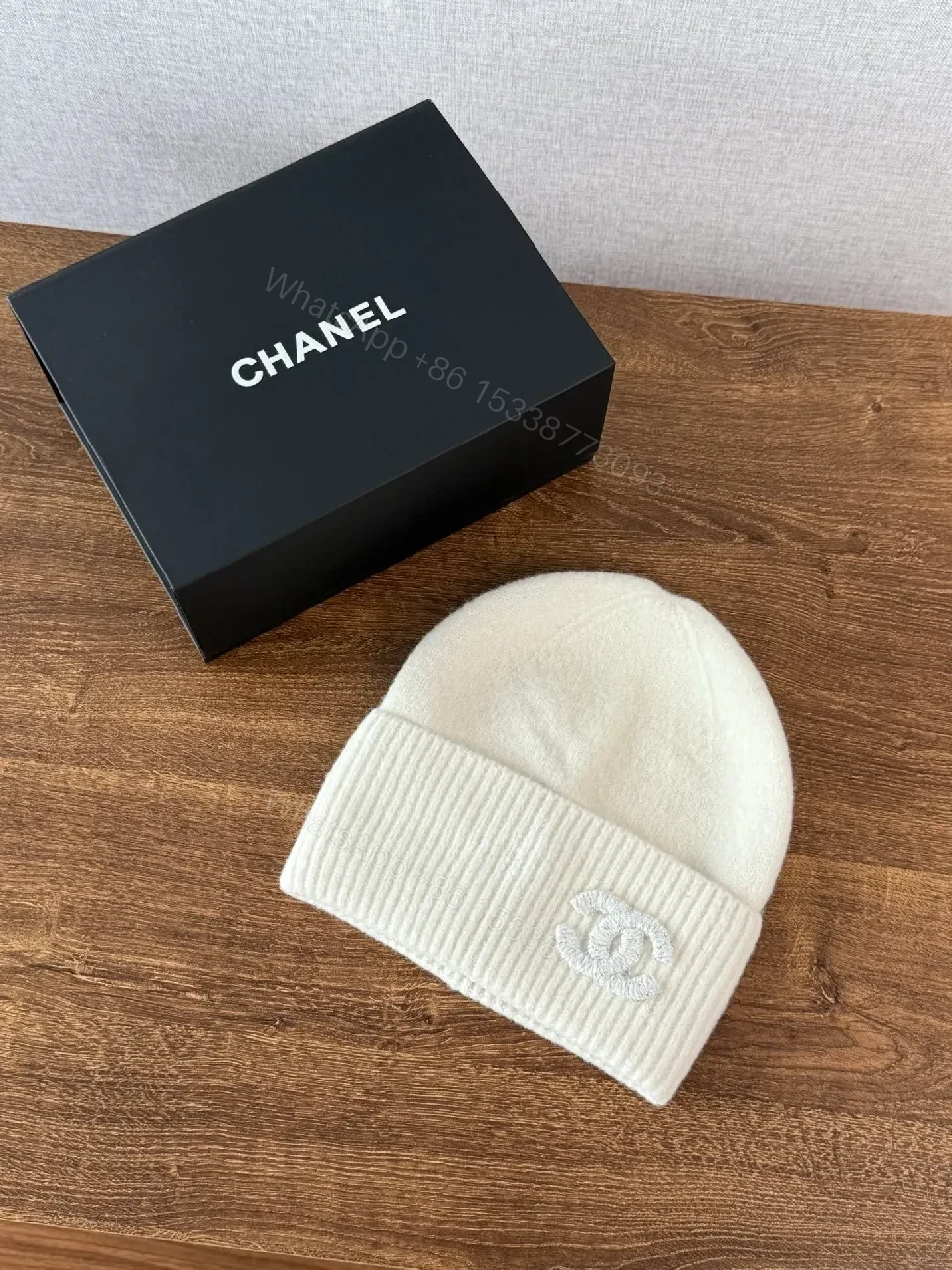 Chic Minimalism Beanie: Off-White Knit, Embroidered Logo, Everyday Luxury — view 1