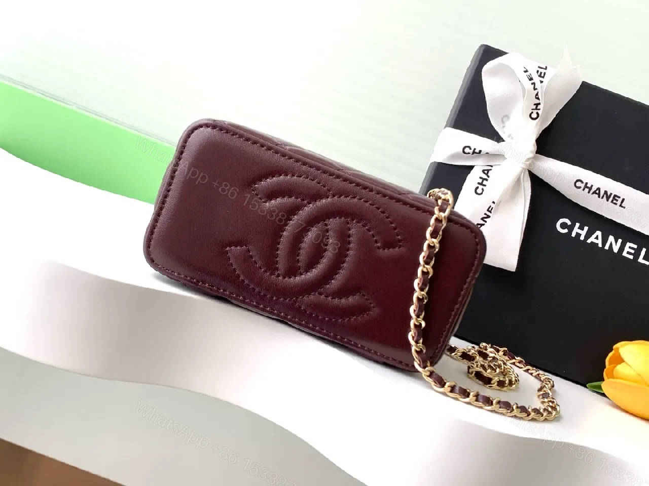 View 3 of Quilted Burgundy Bag with Gold Chain Handle—Compact Luxury