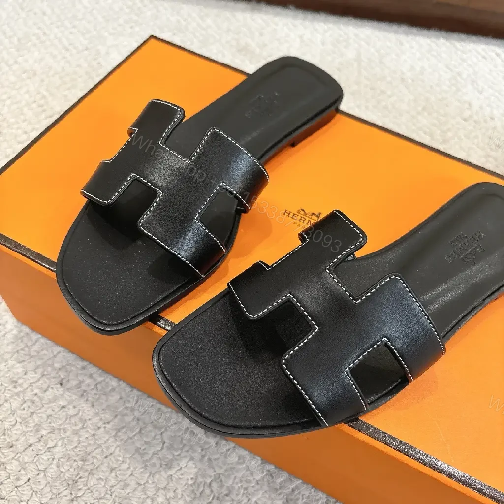 View 3 of black leather slide sandals with H-shaped buckles for luxury everyday
