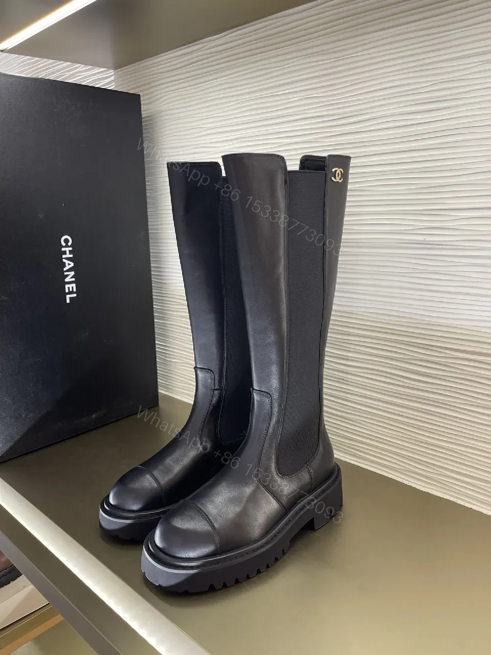 Chic Knee-High Boots with Signature Hardware Leather-Luxe Style — view 1