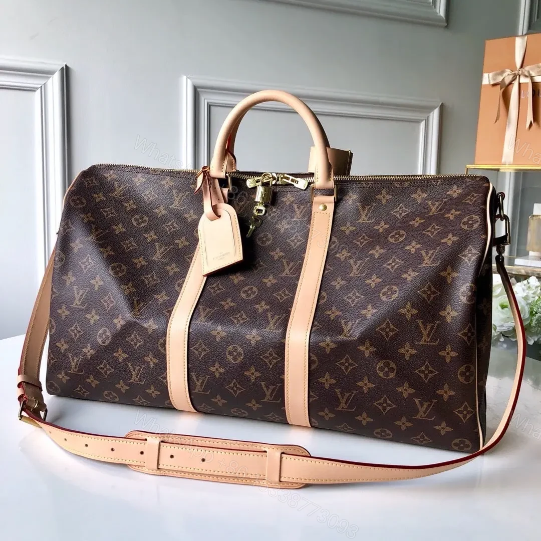 LV Monogram Canvas Keepall Bandoulière 55 Leather Duffle Bag — view 1
