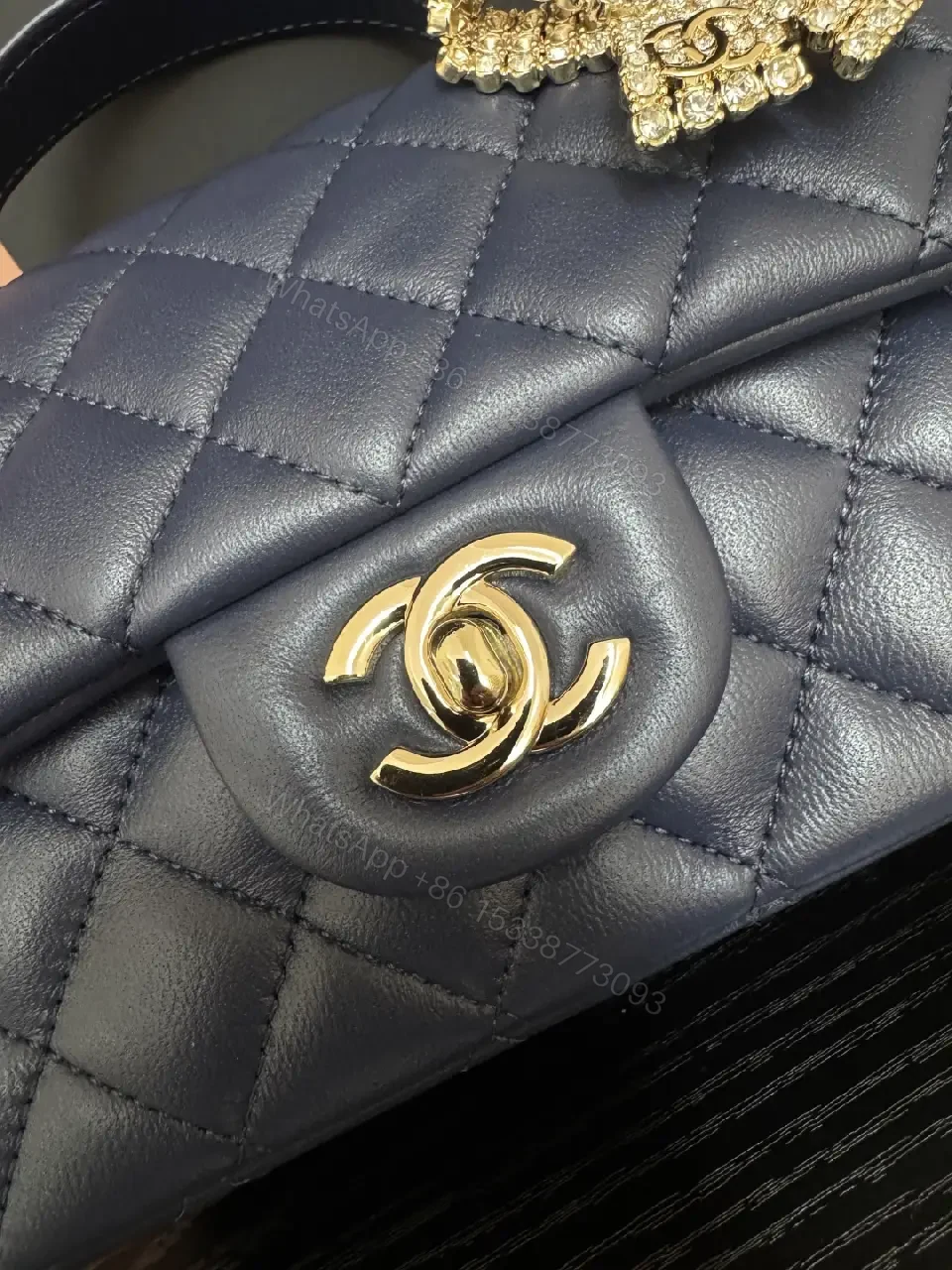 View 9 of Quilted Leather Mini Bag with Gold Emblem - Compact Glamour