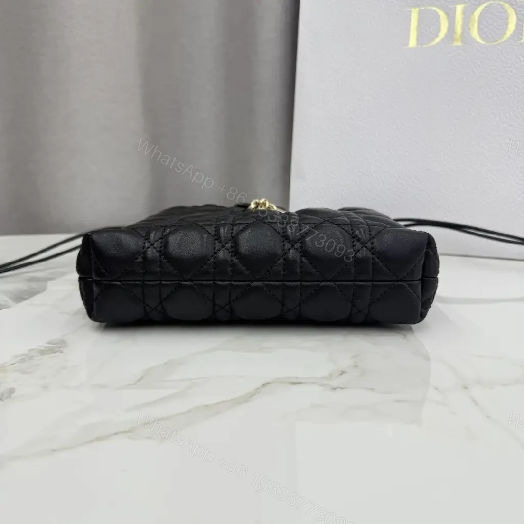 View 3 of Quilted Black Drawstring Bucket Bag with Gold Hardware