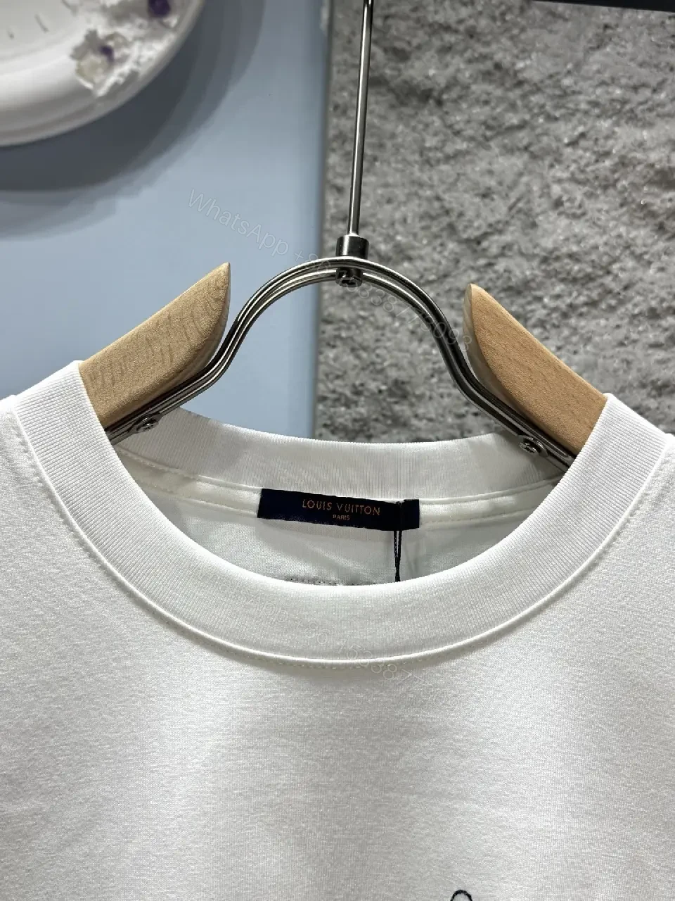 View 3 of Minimalist White Tee with Subtle L.V.M. Logo—Premium Everyday Essential