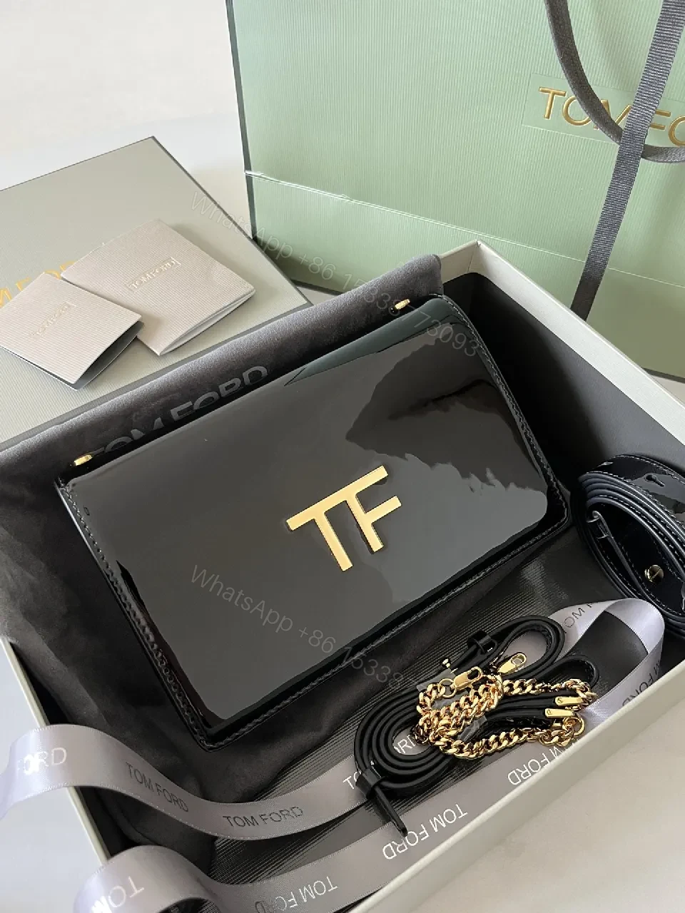 View 2 of Compact Black Leather Crossbody with Gold TF Emblem