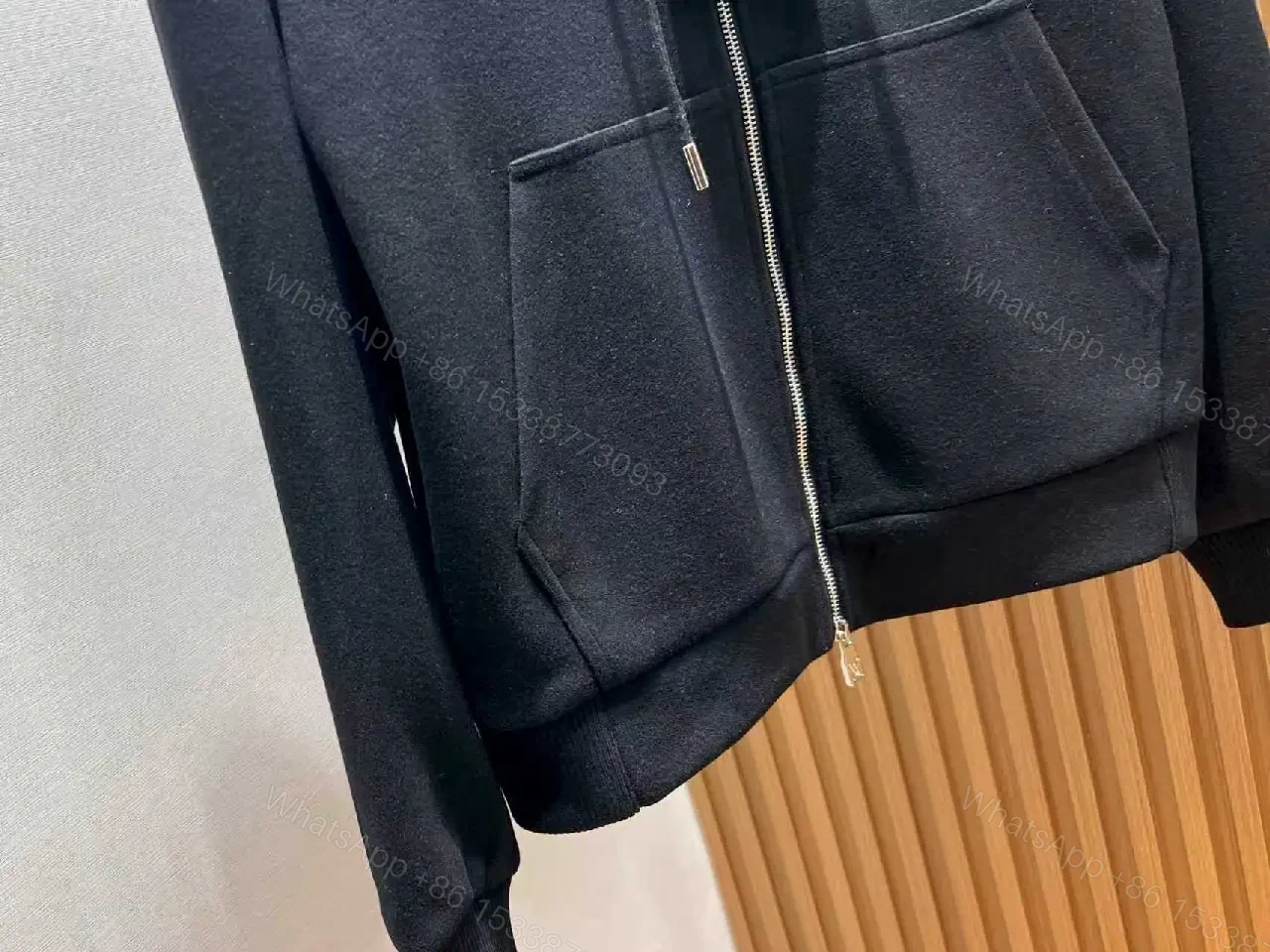View 7 of Cozy Black Knit Zip Hoodie with Subtle Emblem Embellishment