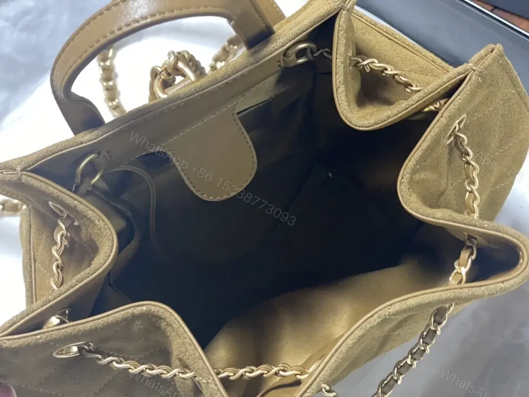 View 8 of Quilted Suede Bucket Bag with Gold Crest Detail