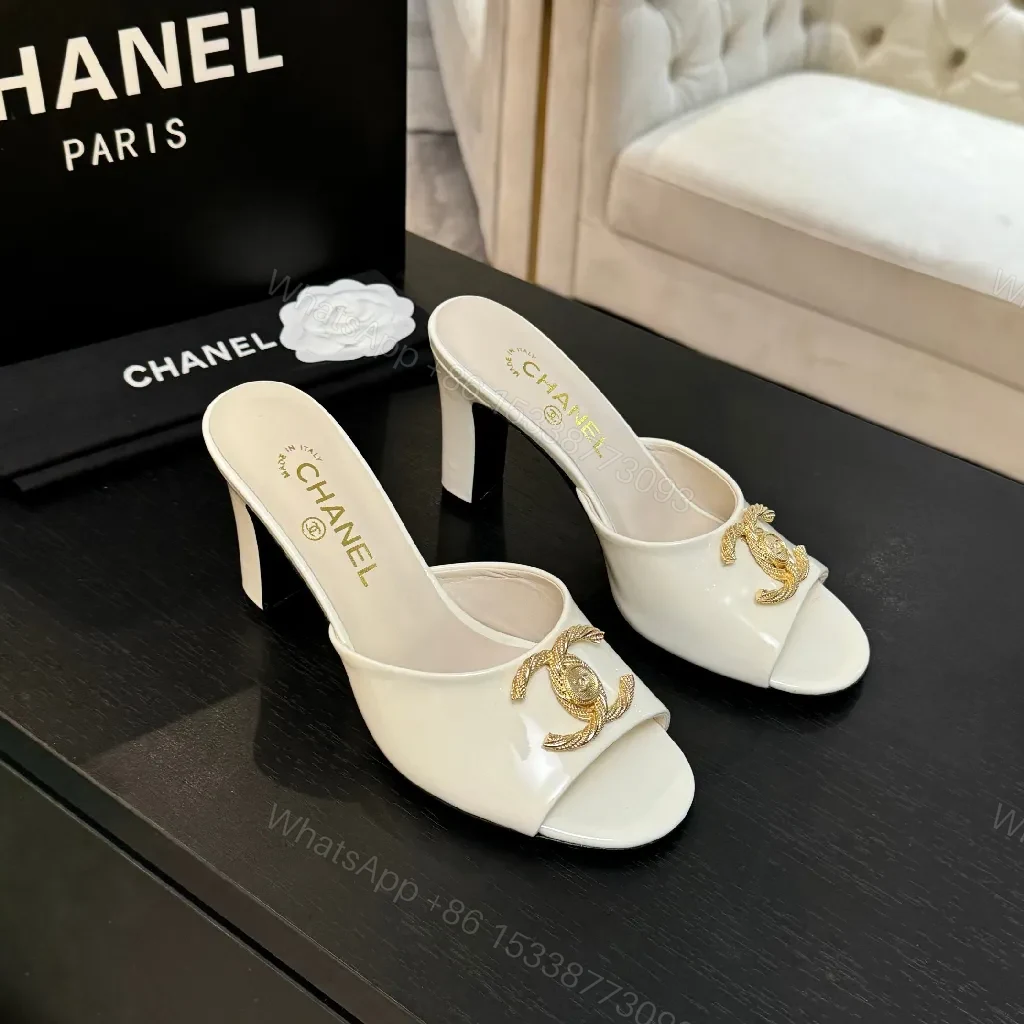 White Patent Mules with Gold Logo Embellishment – Sleek Luxury Footwear — view 1