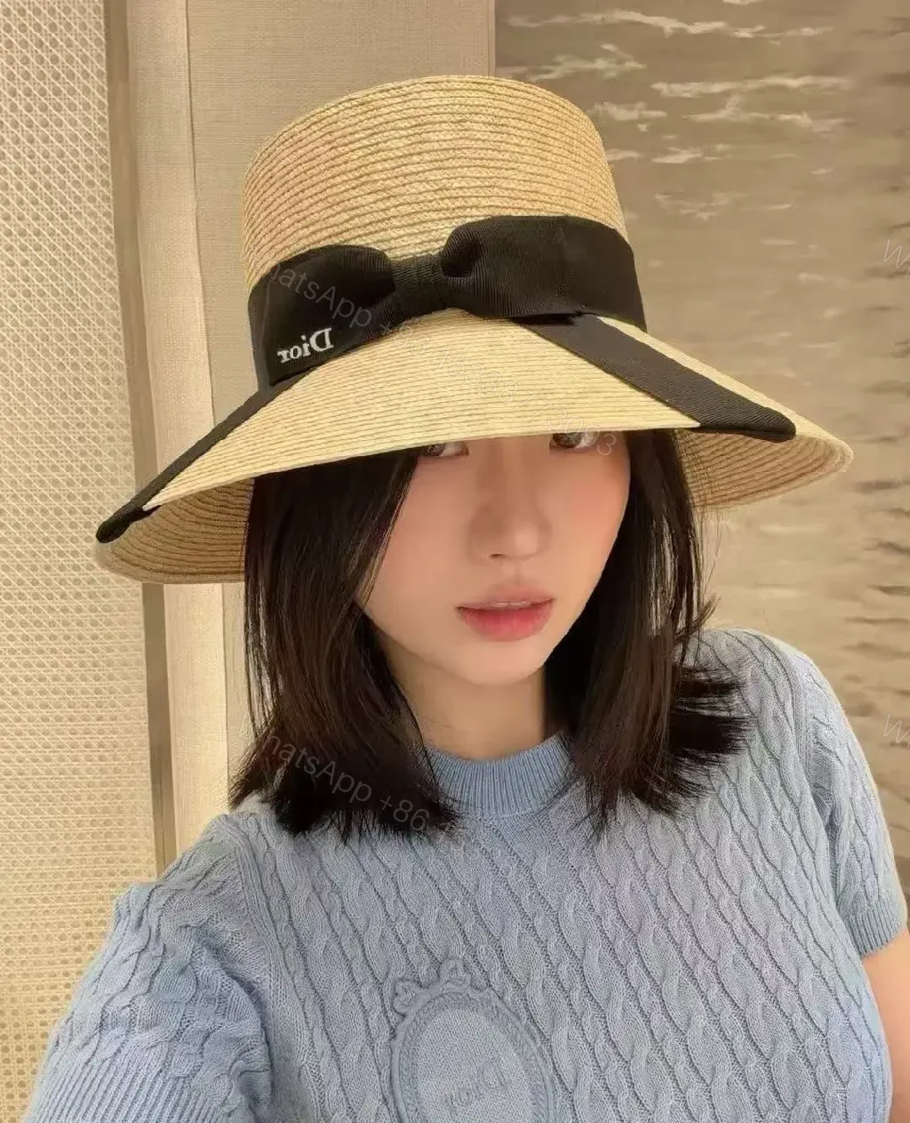 View 3 of Natural Straw Wide-Brim Hat with Black Ribbon Accent