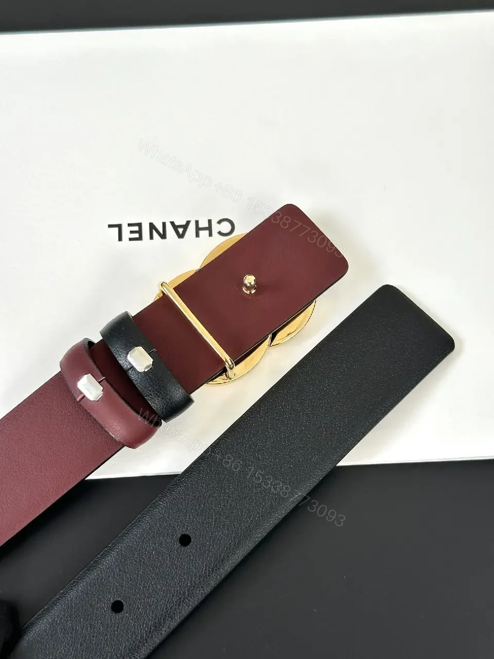 View 2 of Two-Tone Black/Burgundy Leather Belt with Gold Logo Buckle