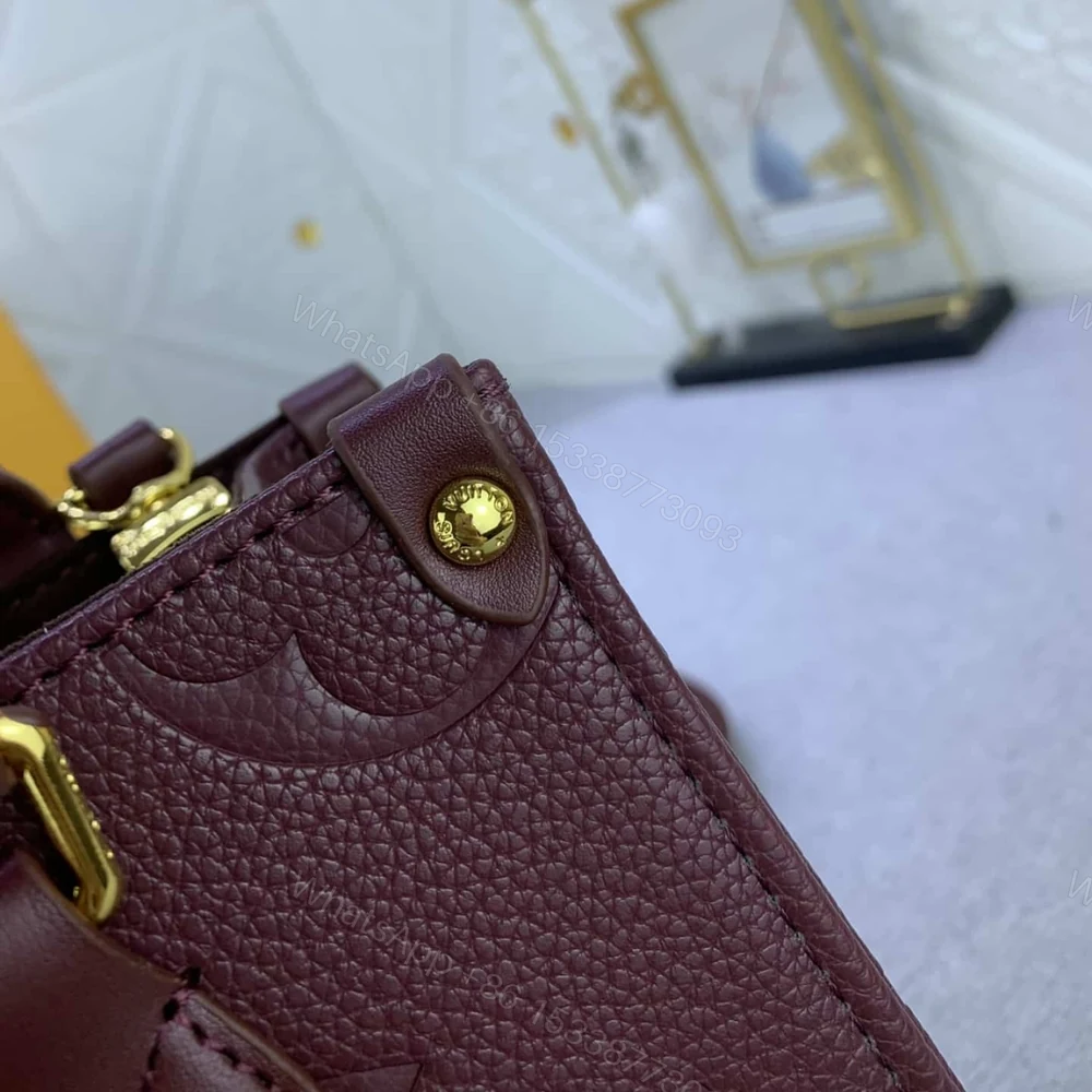 View 5 of Louis Vuitton Onthego MM Monogram Empreinte Wine Red 35Cm M46601