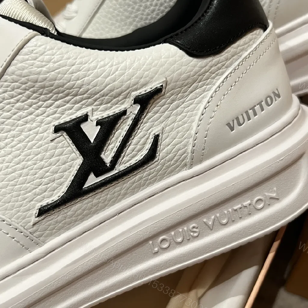 View 6 of Minimalist White Leather Sneakers with Signature Detail - Modern Luxury