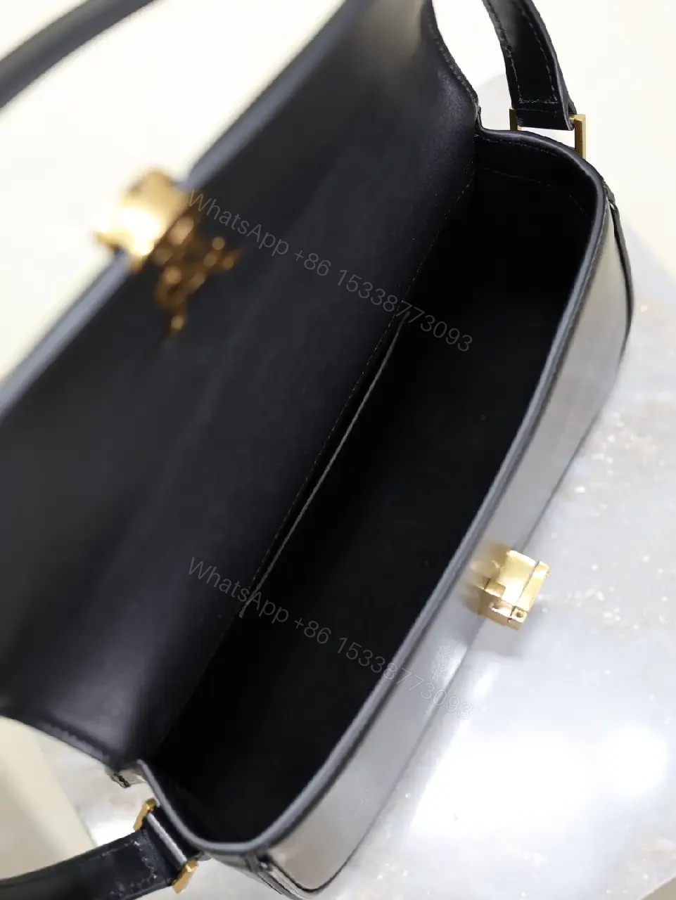 View 9 of Compact Black Leather Shoulder Bag with Gold Hardware