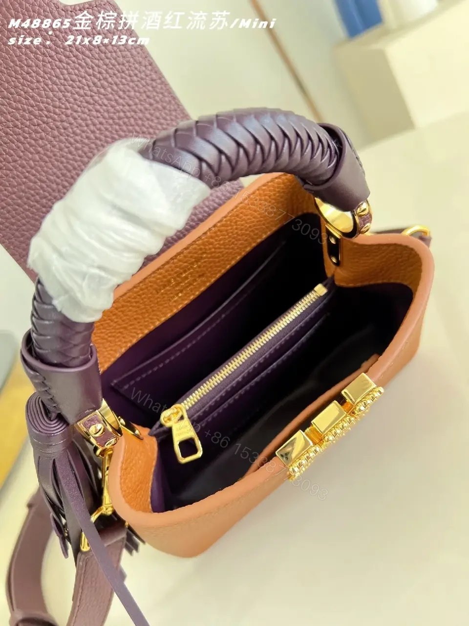 View 4 of Caramel Leather Mini Bag: Structured, Gold Emblem, Compact Luxury