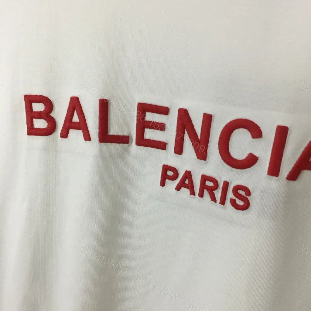 View 8 of Minimalist White Logo Tee with Bold Red Crest