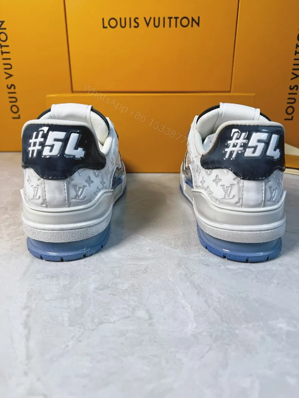 View 5 of Bold Navy Leather Textured Sneakers with LV Accent