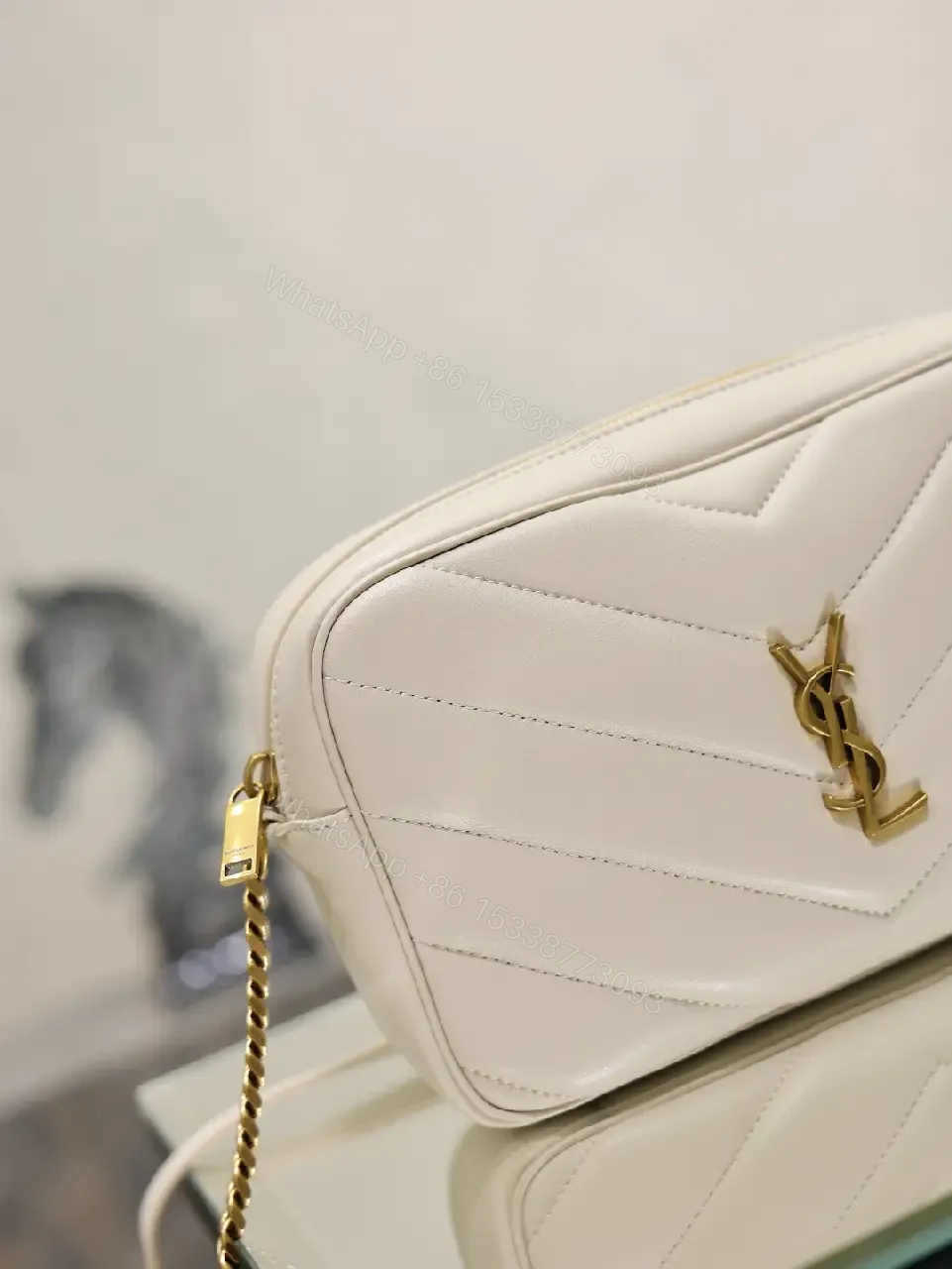 View 4 of Off-White Cream Quilted Chevron Crossbody Bag with Gold Logo