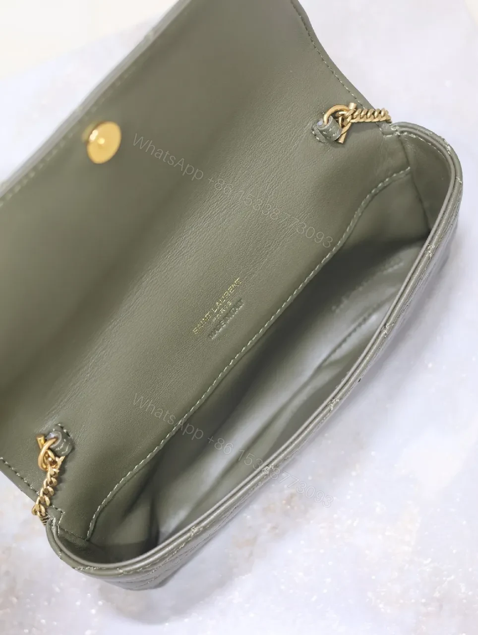 View 2 of Soft-Quilted Leather Clutch with Gold Emblem, Evening Style, Compact Luxury