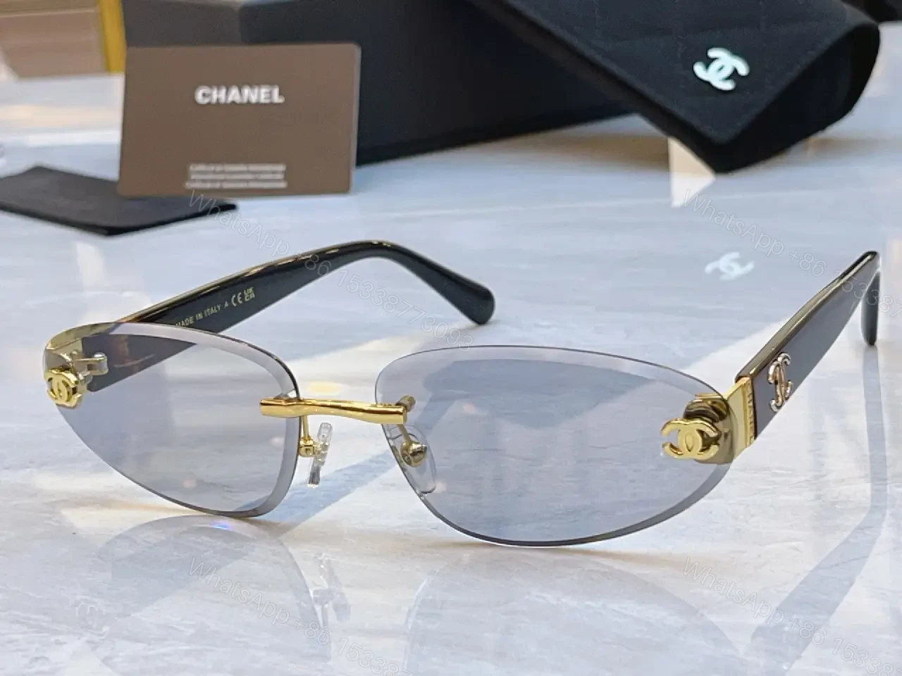 View 2 of Luxurious Silver-Gray Sunglasses: Gold Accents, Semi-Rimless Oval, Chanel Hardware