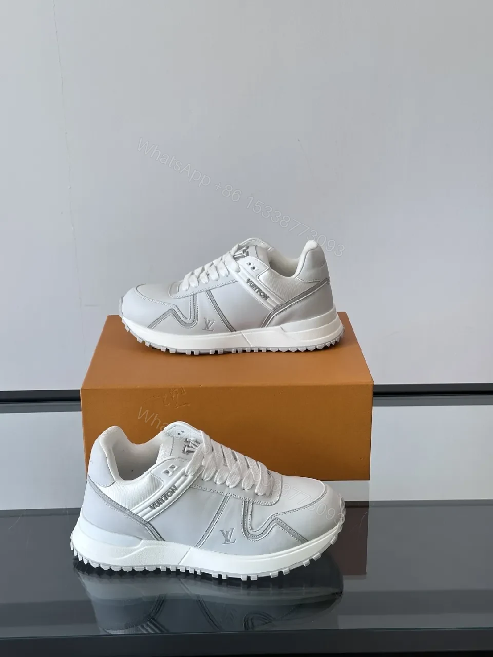 Minimalistic White Leather Sneakers with Subtle Texture and Monogram Accent — view 1