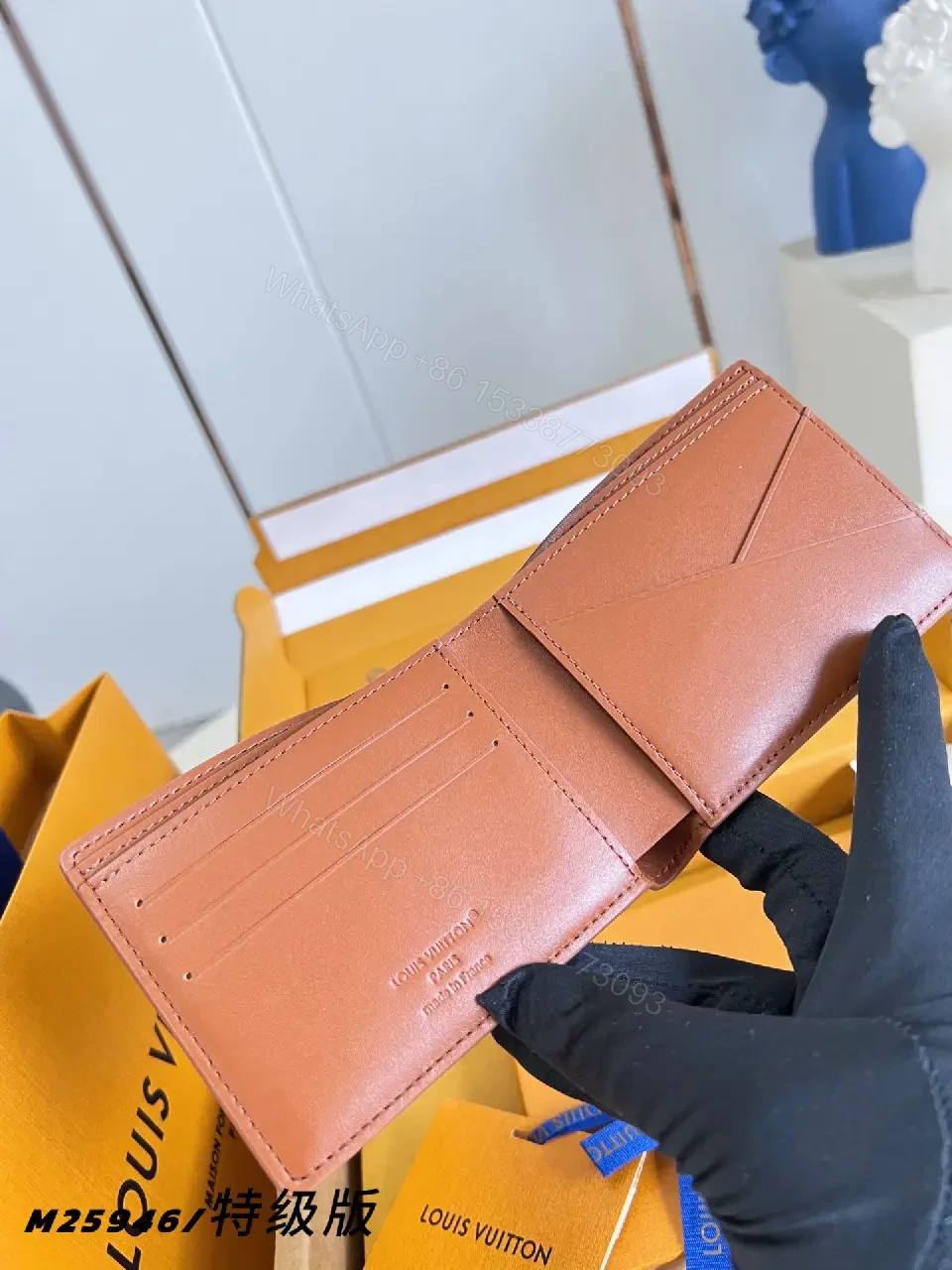 View 2 of Pink-Peach Pebbled Leather Bi-fold Wallet with LV Logo