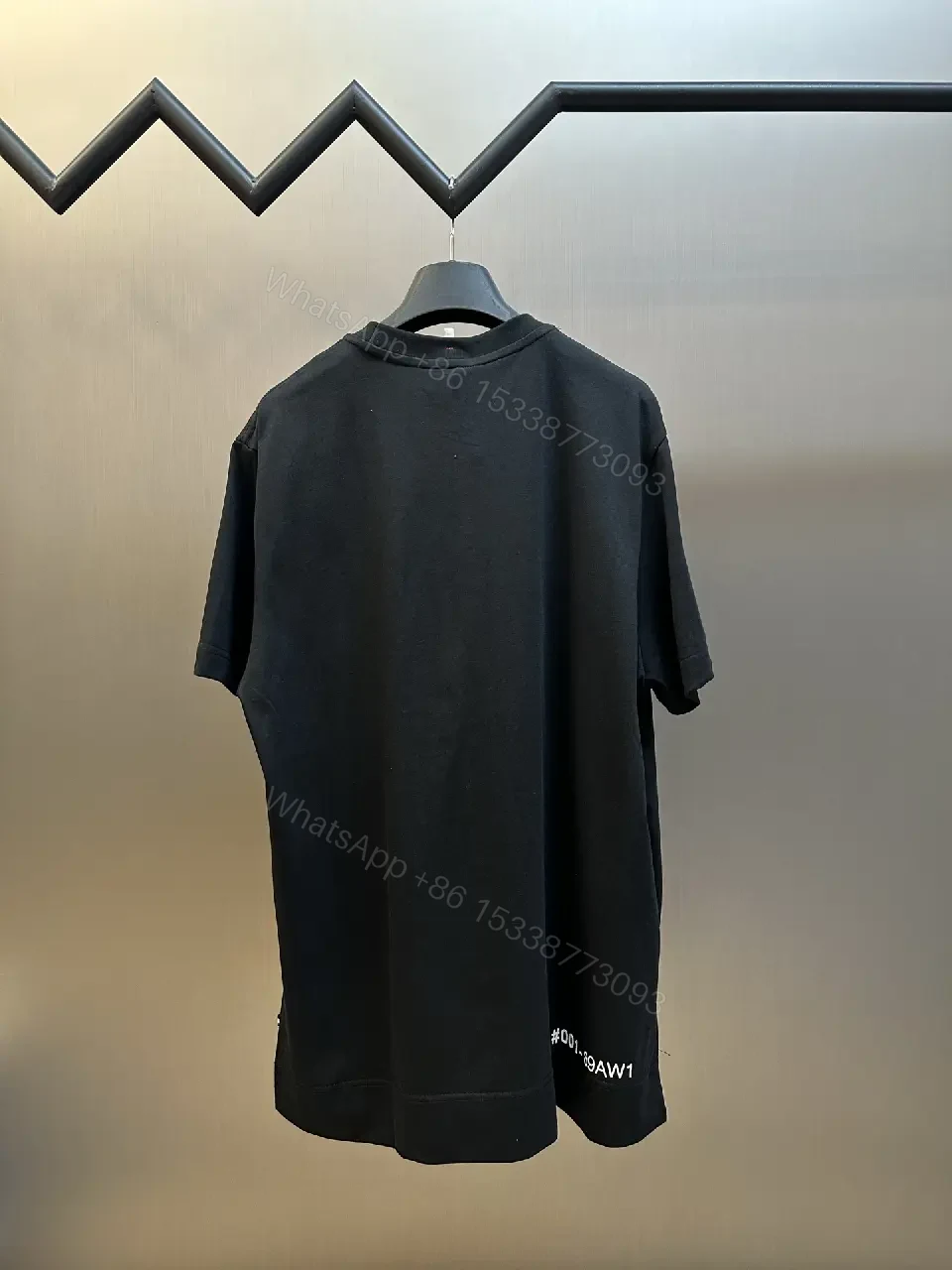 View 9 of Minimalist Black Tee with Logo Crest, Relaxed Fit, Premium Cotton