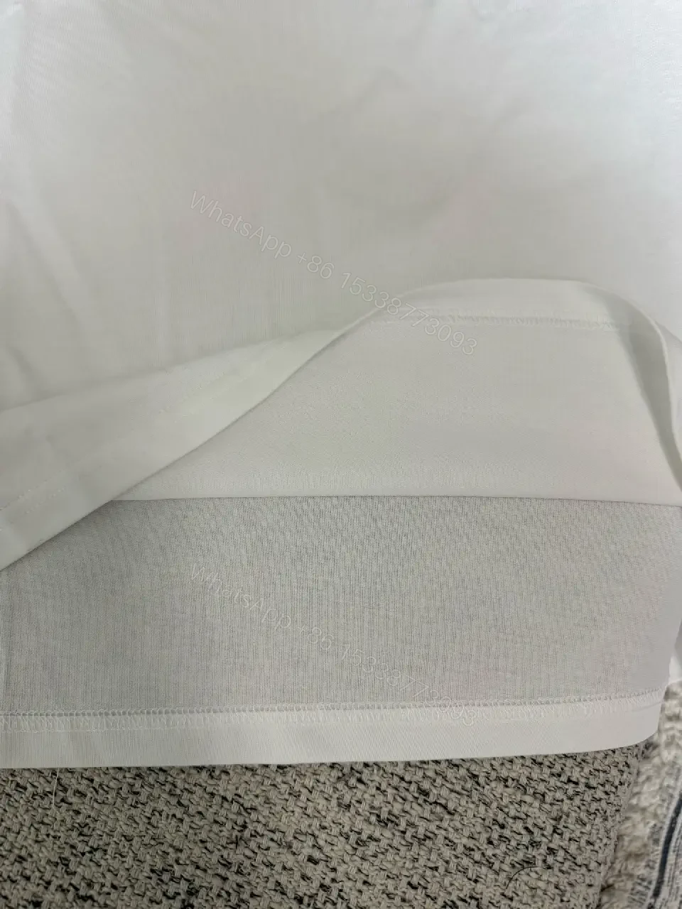 View 4 of Minimalist White Cotton Tee with Subtle Logo