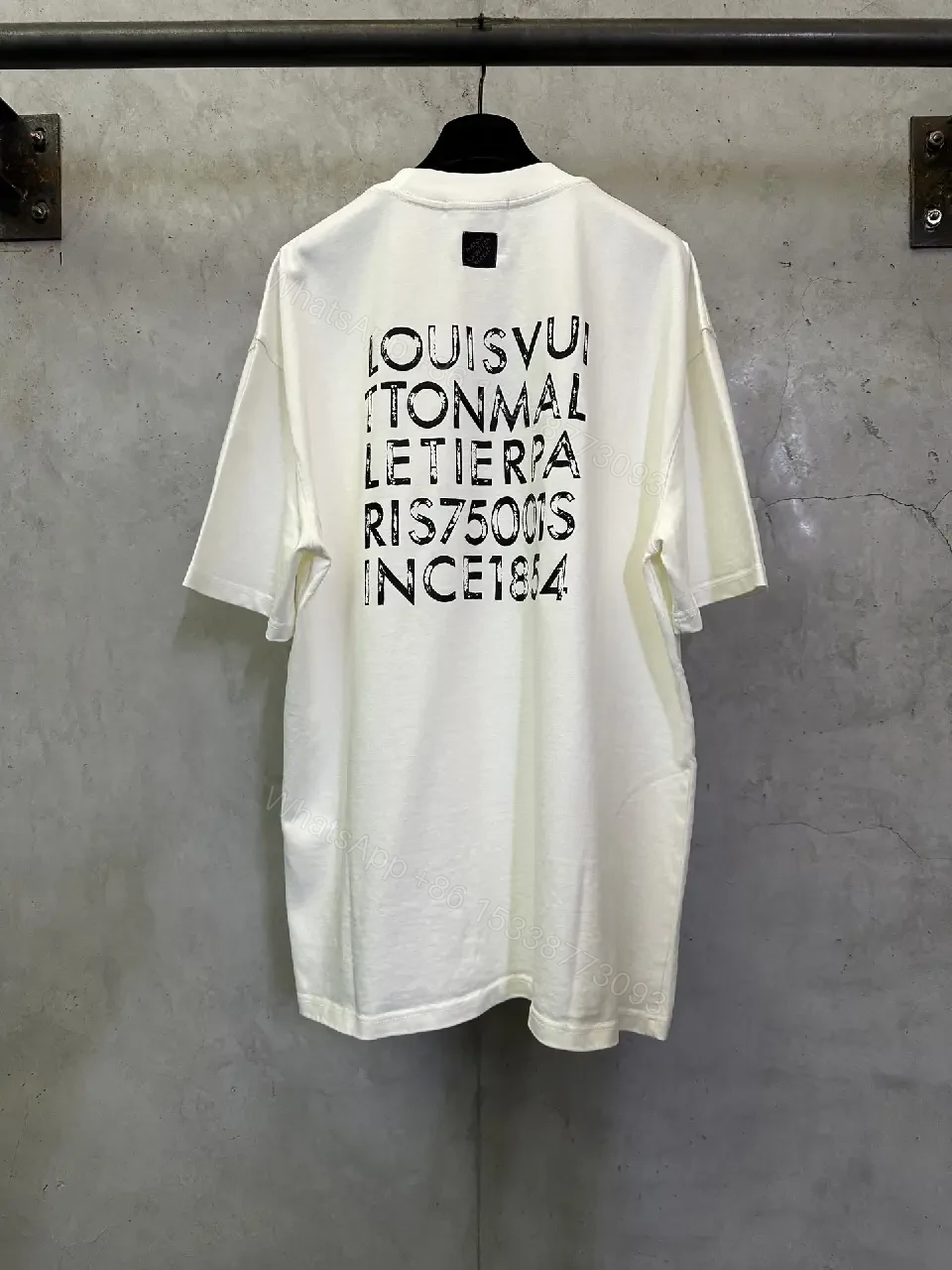View 6 of Minimalist White Tee with Subtle LV.M. Marking — Premium Everyday Wear