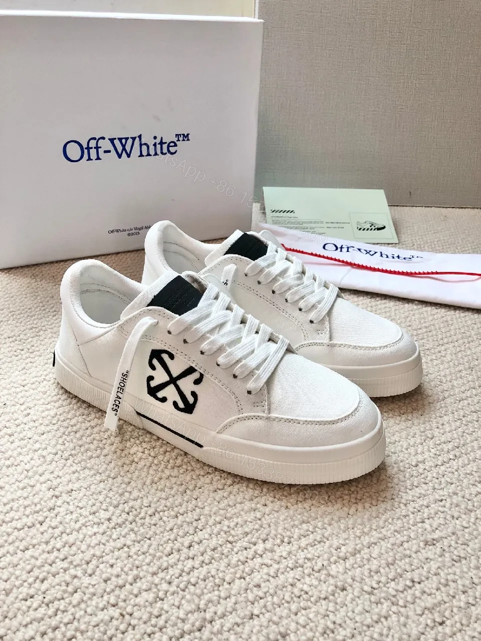 Minimalist White Leather Low-Top Sneakers with Signature Detail — view 1