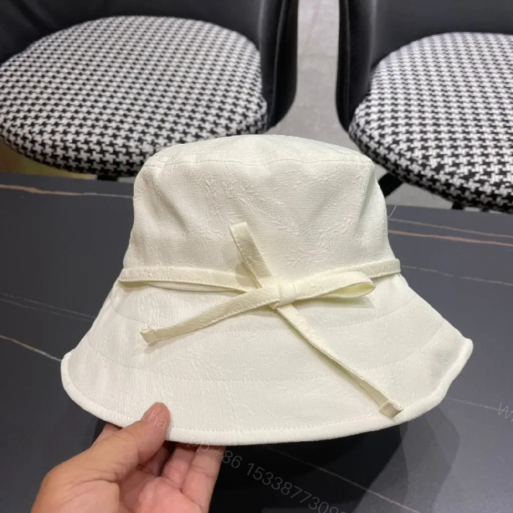View 9 of Compact Luxury Bucket Hat with TriangleEmblem, Off-White, Textured Weave